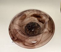 Top view of the purple glass vase showing swirling internal patterns and attached flower frog in the center