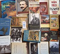 Top-down view of 18 books on world history, historical figures, and related topics, arranged closely with visible titles including Einstein biography and Barbara Tuchman's works.