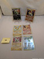 Front view of six 2007 Secret Wonders Pokemon holo cards including Entei and Tyranitar, showing holographic details and swirl effects.