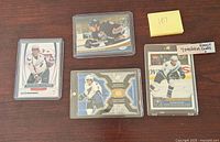 Four Alexander Ovechkin rookie hockey cards in protective cases displayed on a wooden surface.