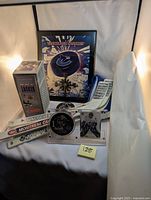 Photo showing Vancouver Canucks clock, Roberto Luongo puck and card display, souvenir puck, and mini hockey sticks with various NHL team logos.