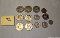 Set of 14 coins including half dollars, quarters, a nickel, and the rare 1979 Susan B. Anthony dollar with filled D mint mark error.