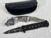 Smith & Wesson ExtremeOps folding knife and Franklin Mint wolf collector folding knife with case