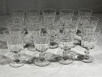 Front view showing all 14 Lenox crystal wine glasses arranged in rows on a surface, highlighting the quantity and uniformity of the set.