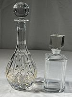 Two glass decanters side by side showing full height and design
