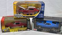 Set of three 1/24 scale Ford Mustang model cars in sealed boxes with original packaging visible