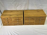 Two wooden parts drawer cabinets shown side by side, each with eight drawers and metal knobs.