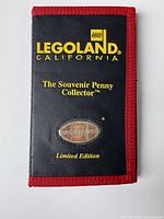 Closed view of the souvenir penny collector book with Legoland California branding and limited edition text.