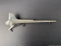 Side view of the entire chrome hood ornament showing long, aerodynamic shape with Native American head front.