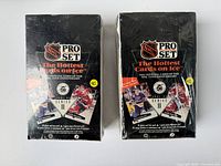 Two factory sealed boxes of NHL Pro Set 1991-92 Series II hockey cards with original shrink wrap intact showing signs of age and shelf wear.