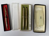 Three vintage Cross gold tone pens and mechanical pencils, each in original boxes or with papers.