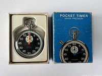 Stopwatch in original box alongside box showing front label