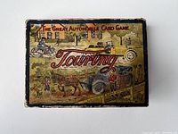 Box of The Great Automobile Card Game titled Touring with vintage illustrated cover showing automobiles, cyclists, and pedestrians.