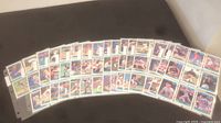 Photo showing an array of 1992 Donruss baseball cards fanned out on a flat surface, highlighting various player images and card designs.