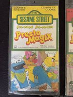 Original sealed Sesame Street Presto Magix sticker pack featuring Cookie's Kitchen theme with Cookie Monster and Bert, rub-down transfers in original mint packaging.