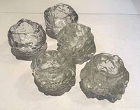 Top view of all five clear glass Snowball votive candleholders showing their textured and sculptural design.