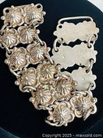 Close-up photo of the vintage Mexican silver sterling bracelet showing detailed floral links and clasp mechanism.