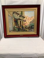 Framed oil painting showing a lively street vegetable market scene in Naples with several people and a horse-drawn carriage.