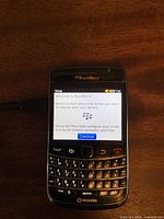 Front view showing BlackBerry Bold 2 device powered on displaying setup screen with Rogers branding.