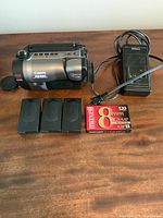 Canon ES980 camcorder, 3 battery packs, battery charger, and Maxell 8mm cassette tape