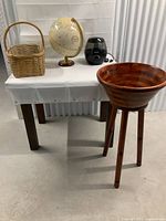 Table with solid maple bowl on legs, vintage globe, Honeywell humidifier, and woven vintage basket.