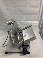 Left-front view showing overall slicer, blade and carriage on white background