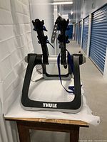 Front three-quarter view showing overall frame and support arms with blue rubber straps