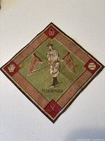 Front view of the 1914 tobacco felt showing Roger Peckinpaugh in uniform with baseball-themed icons around the edge.