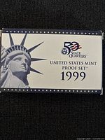 Front of the original US Mint proof set box for 1999 50 State Quarters, featuring Statue of Liberty and 50 State Quarters logo.