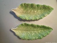 Top view of two matching Royal Winton Grimwades leaf bowls with green and white glaze, showing the detailed veining and leaf shape.