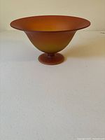 Front angled view of the orange and yellow gradient art glass bowl showing the flared wide opening and pedestal base.
