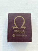 Closed Omega Super Lighter original box, burgundy color with gold Omega logo and Superlighter branding.