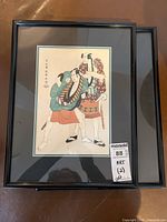 Framed print showing two traditional Asian men in robes in colorful clothing, framed with black frame and double mats.