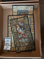 Three Asian needlepoint embroidered textile artworks stacked together showing intricate stitching and rich color detail.