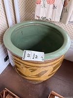 Full view of the Asian ceramic plant pot showing the green glazed interior and the brown exterior with a dragon design.