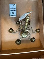 Top-down view showing six candlestick holders on curved arms, confirming the number of arms and candle cups.