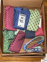 Box containing multiple men’s neckties with various colorful patterns including Vineyard Vines Martha’s Vineyard.