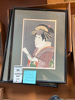 Two framed Japanese wood block prints stacked, showing the top print's image