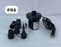 AGPTEK electric air pump with cord, car adapter, wall adapter, and three nozzle attachments arranged on a white background.