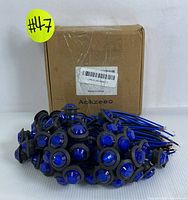 Lot of Aokzeeo blue 3/4 inch waterproof LED lights prewired with blue and black wires, shown with manufacturer box in background.