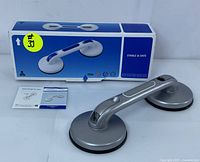 Grab bar displayed with original box and user manual showing product details and condition.