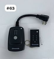 Dewenwils outdoor remote control outlet with short power cord and wireless remote key fob on white background, labeled #63.