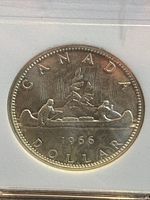 Reverse side of the 1966 Canadian 1 Dollar coin featuring a canoe with two paddlers and the date '1966' with denomination and country name.