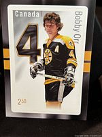 Front side of the collectible stamp featuring Bobby Orr in Boston Bruins uniform, showing his player number 4 and denomination of $2.50.