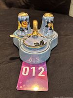 Front and top view of the full Japanese Noritake cruet set with floral lustre design, showing salt, pepper, mustard pot with lid and spoon on stand.