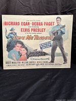 Front view of the vintage Love Me Tender Elvis Presley theatrical movie lobby card showing the full poster with the title, cast names, and Elvis Presley playing guitar.