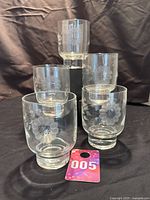 Set of five Hughes Cornflower juice glasses shown from front view with pedestal bases visible. Includes numbered tag '005'.
