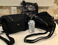 Three crossbody bags with can for scale