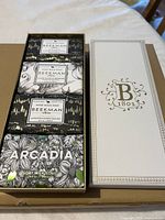 Open gift box showing four Beekman 1802 goat milk soap bars