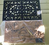 Both door mats together: black rubber mat above, packaged coir mat below